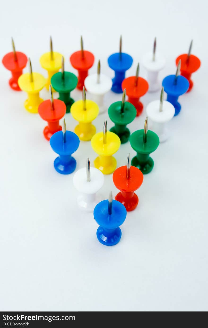 Triangle formation of push pins, conceptual for group of people. Triangle formation of push pins, conceptual for group of people