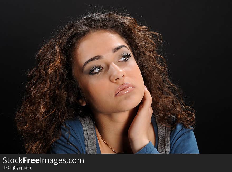 Young beautiful woman's portrait over black