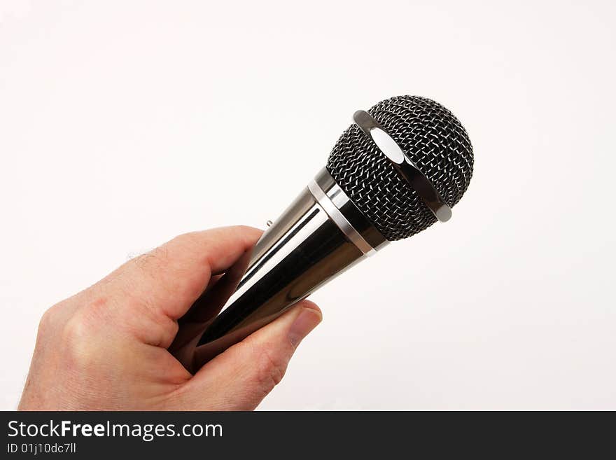 Hand held microphone in use, over white. Hand held microphone in use, over white.