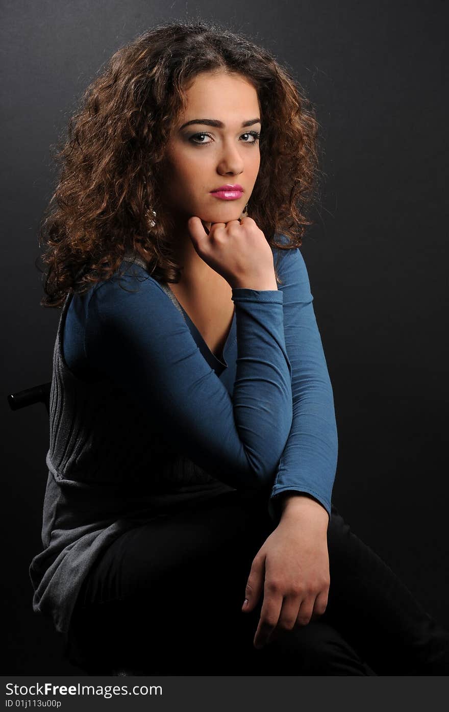 Beautiful model with curly hair over black