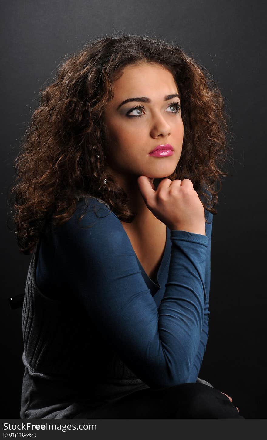 Beautiful model with curly hair over black