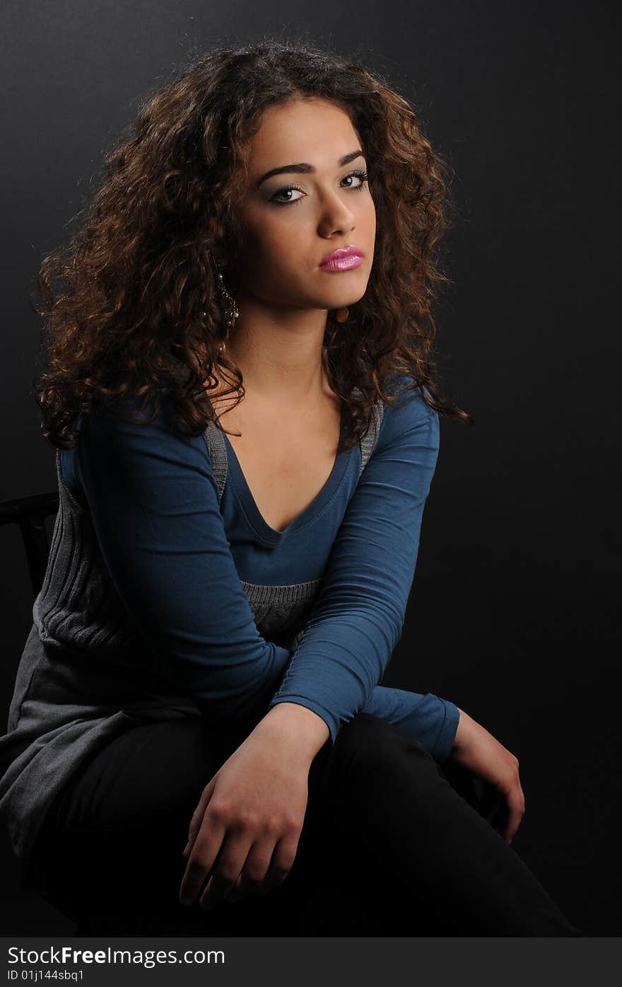 Beautiful model with curly hair over black