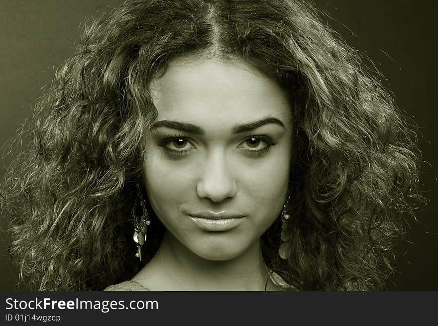 Beautiful model with curly hair over black