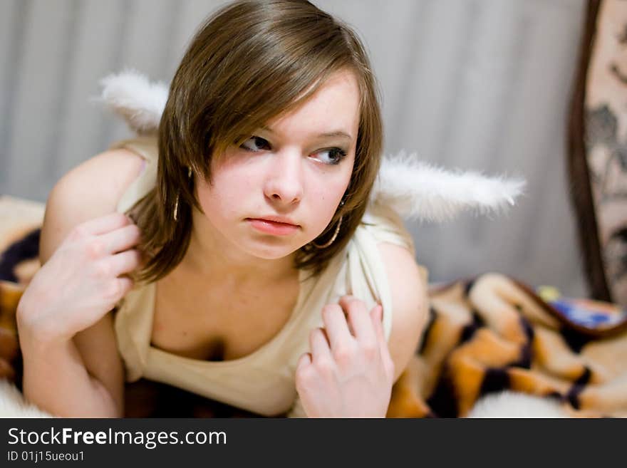 Beautiful girl with white wings behind their backs. Beautiful girl with white wings behind their backs