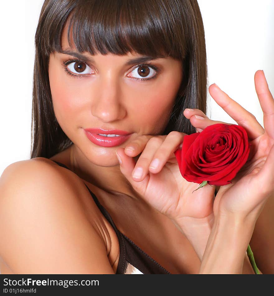 Portrait of the beautiful girl with a scarlet rose in hands. Portrait of the beautiful girl with a scarlet rose in hands