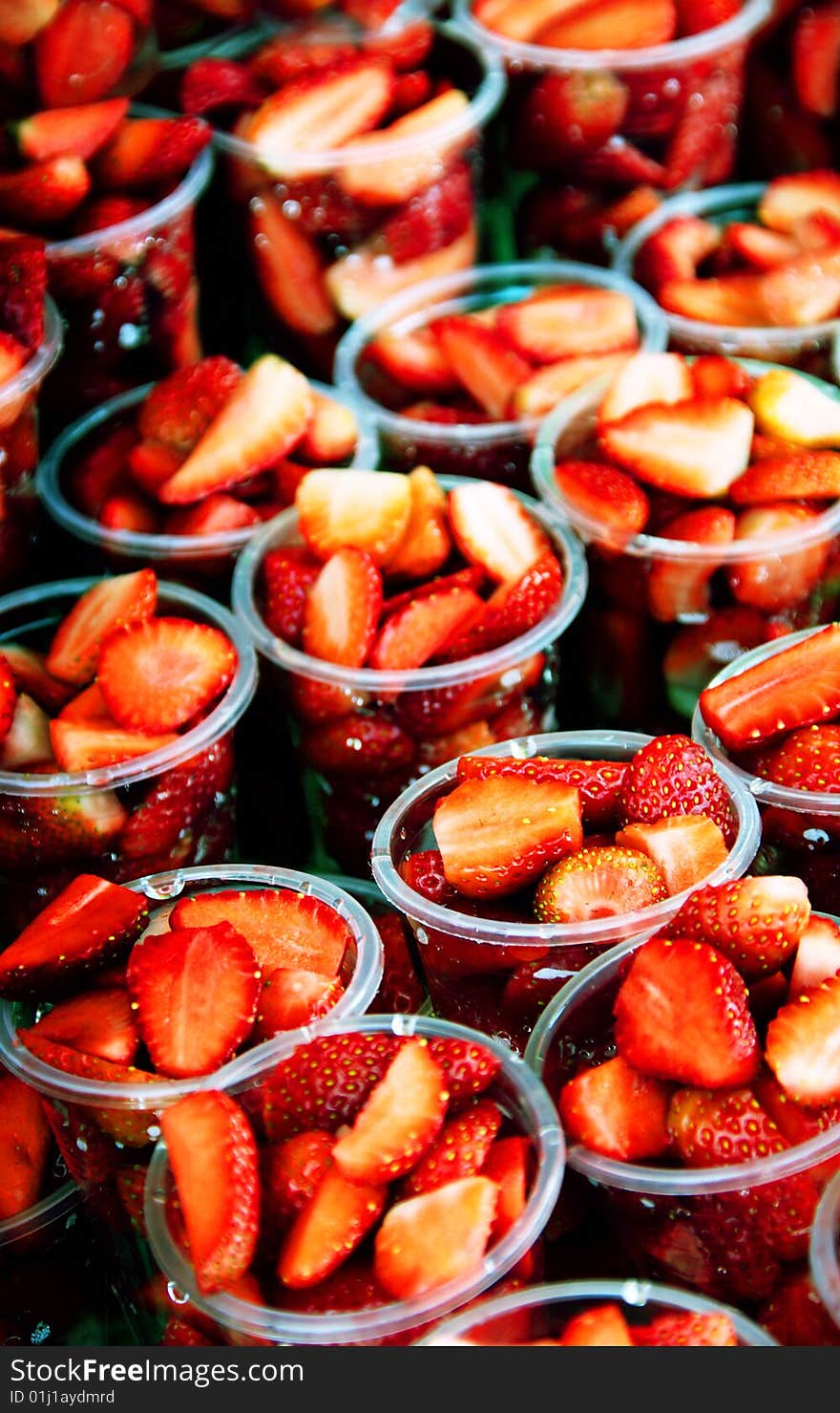 Fresh cut strawberries in cups