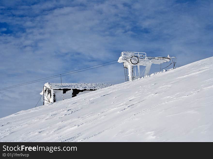 Ski lift covered with hoarfrost and snow