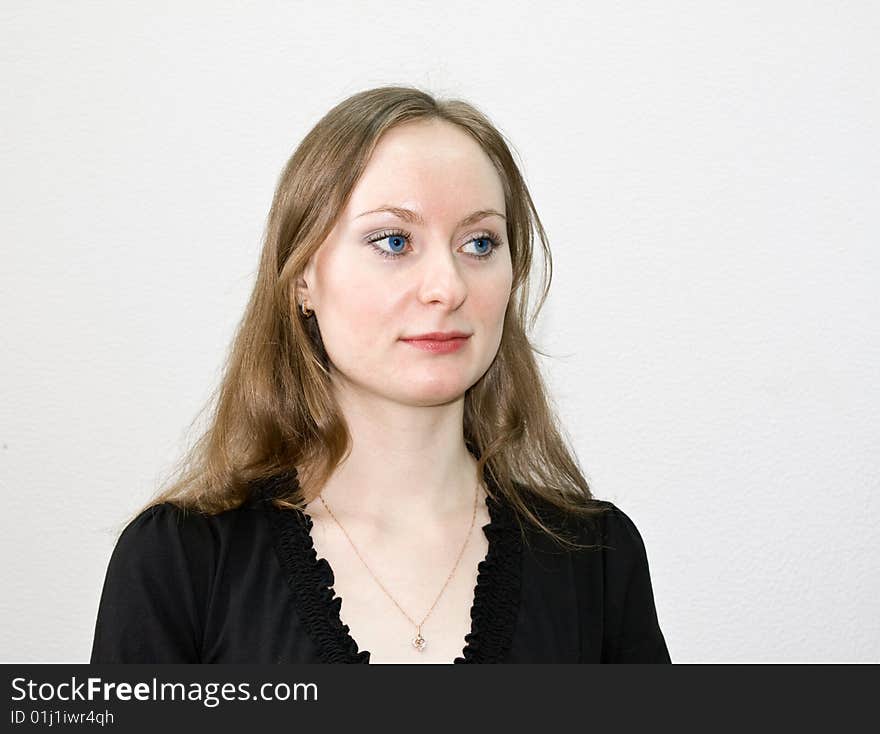 Girl in a black dress, on a white background, with an indifferent sight. Girl in a black dress, on a white background, with an indifferent sight.