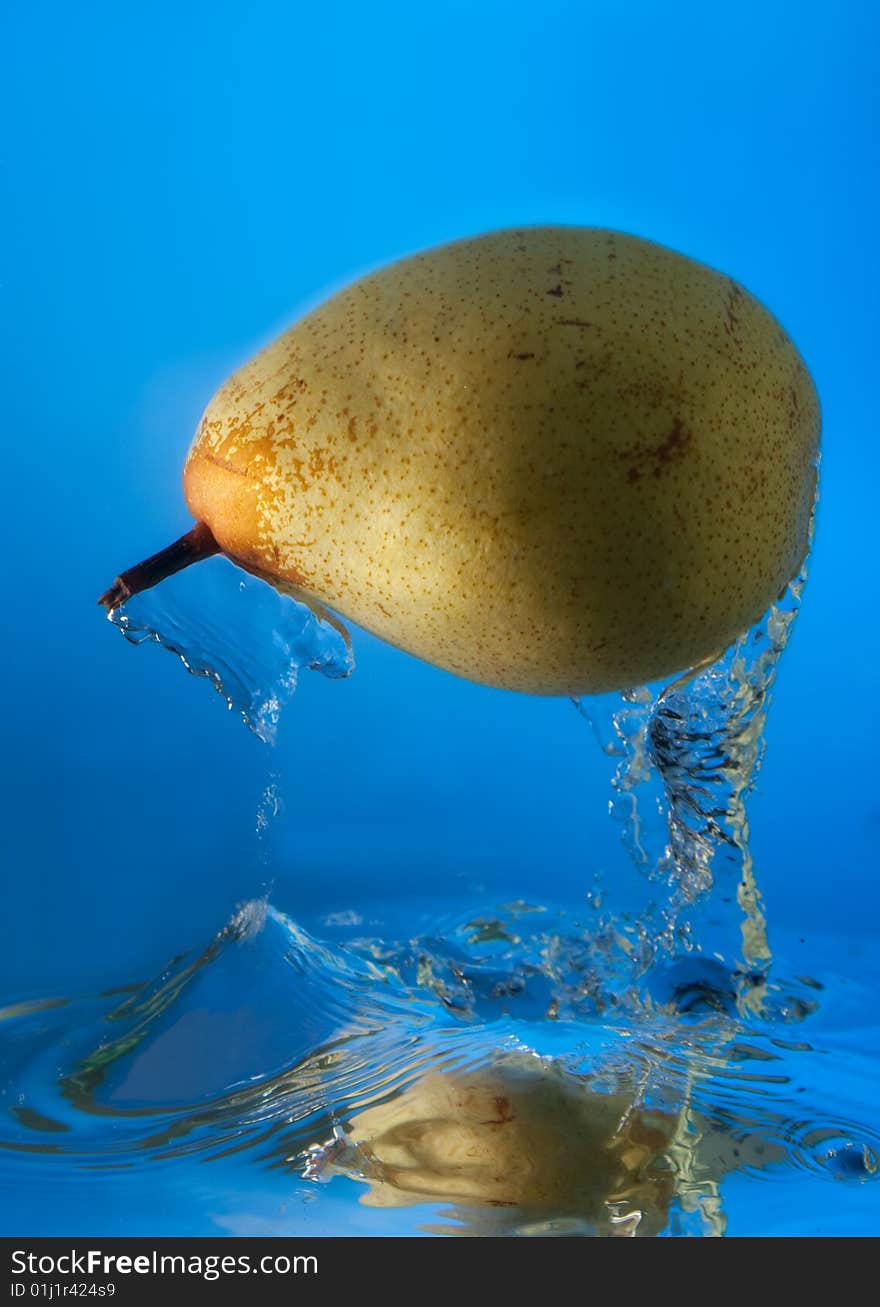 Pear in water on a blue background