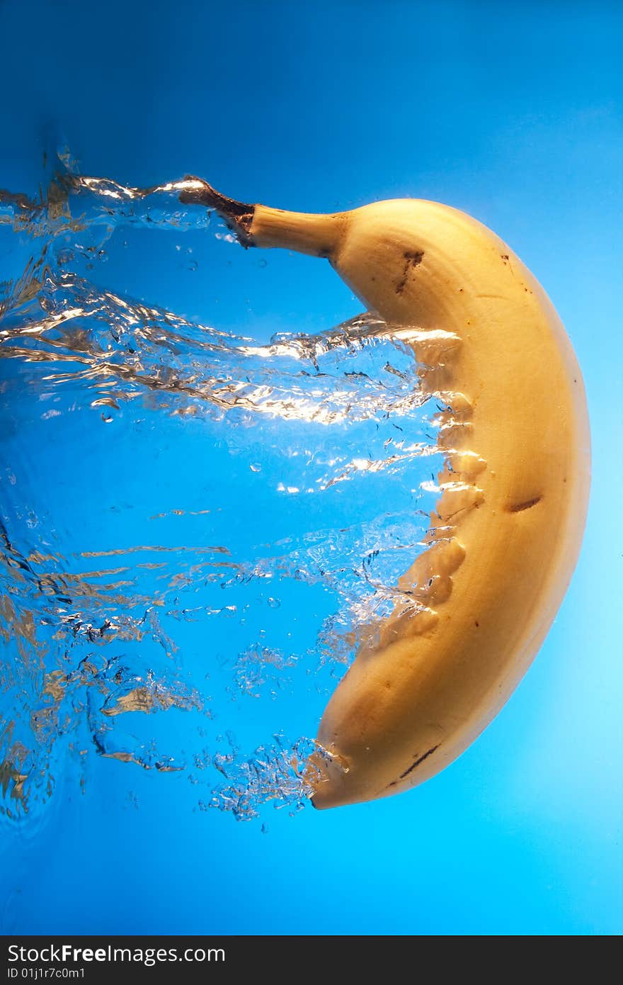 Banana in water on a blue background