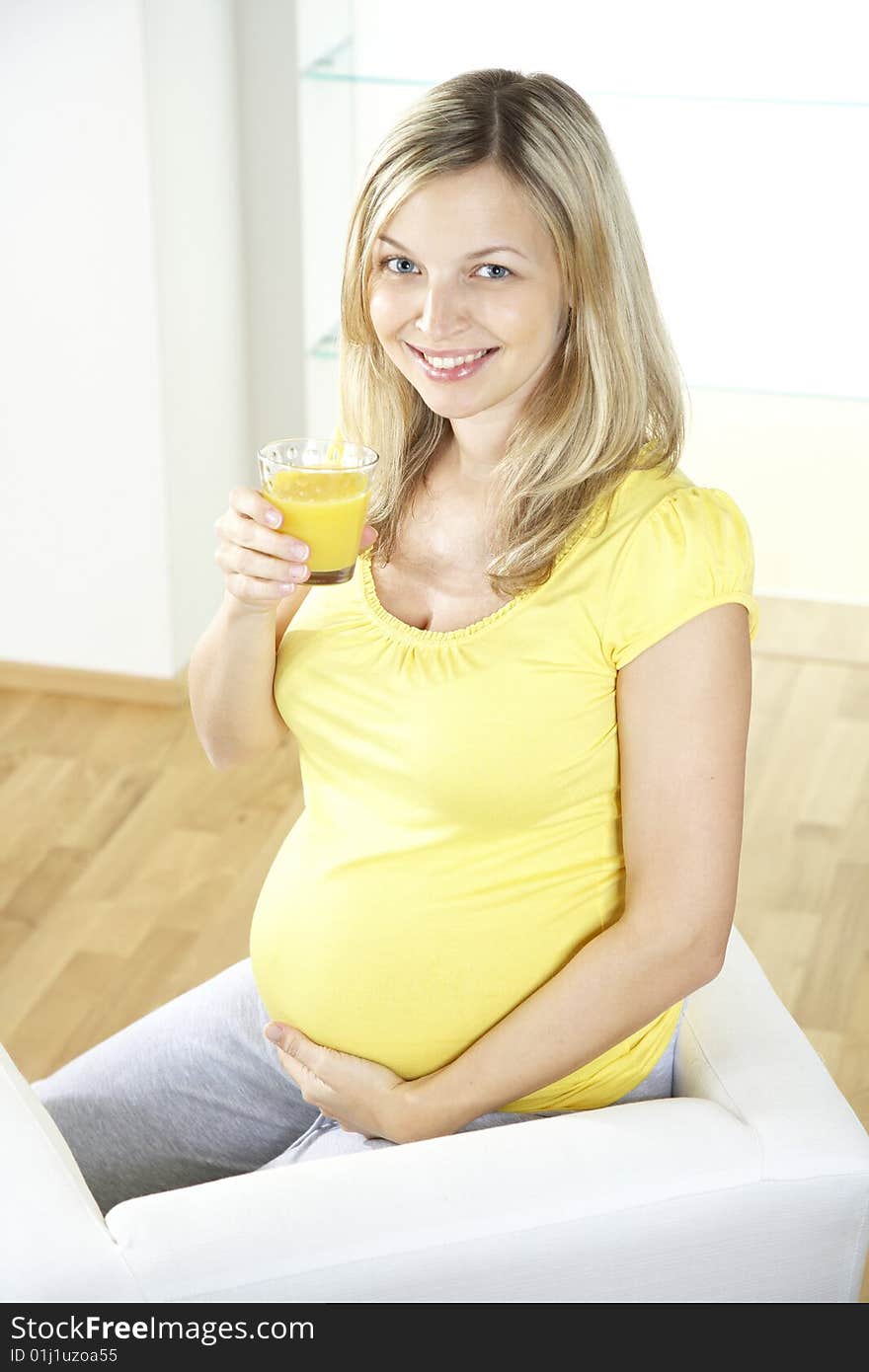 Young pregnant woman with orange juice