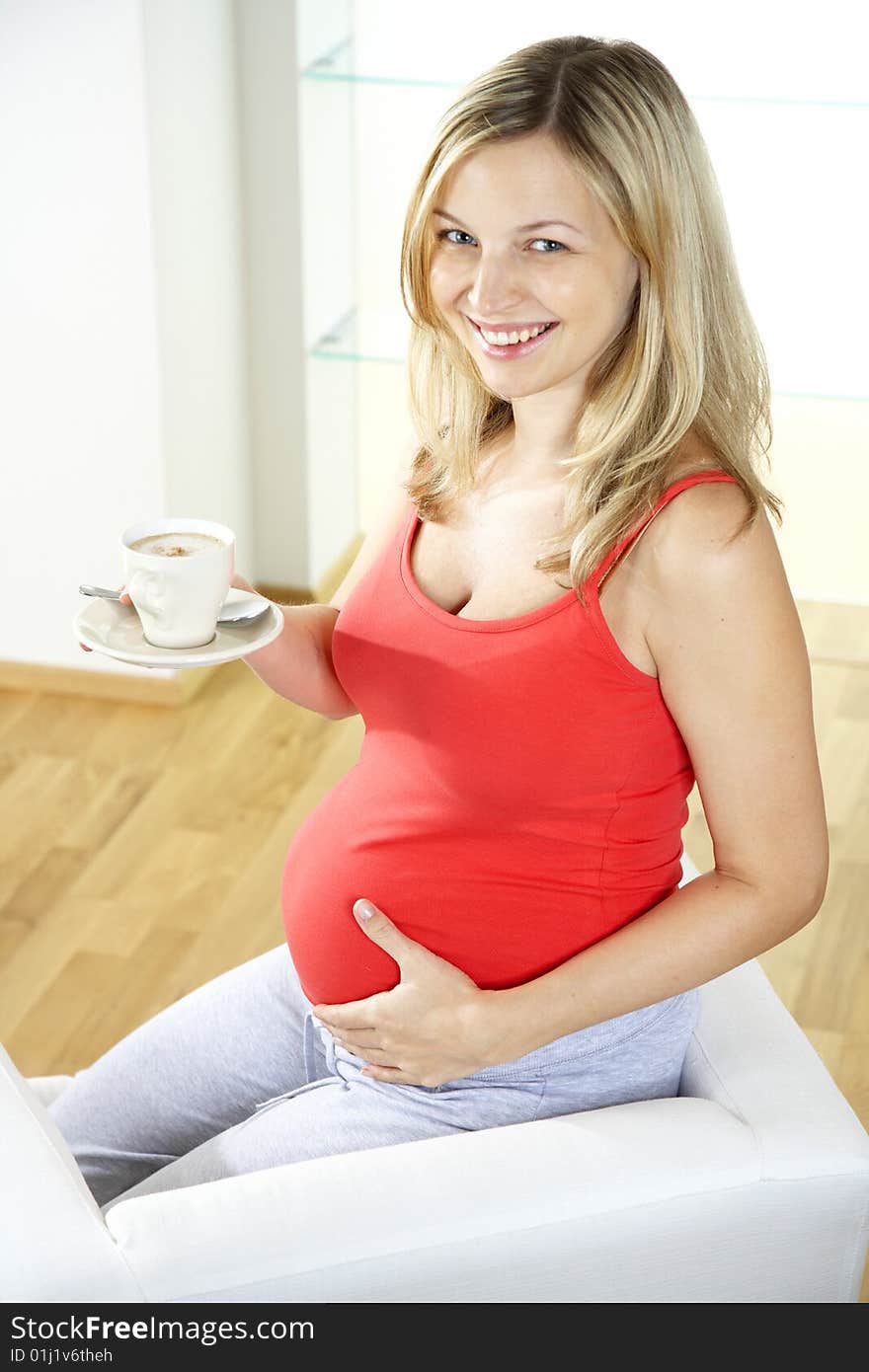 Pregnant woman is drinking coffee