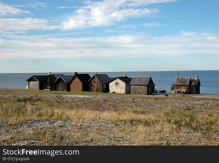 Fishing huts on Gotland, Sweden with the ocean in the background. Fishing huts on Gotland, Sweden with the ocean in the background.