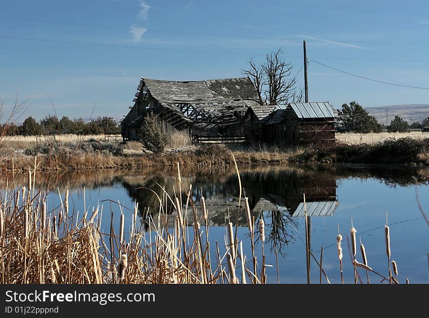 This is an old farm barn that is about to fall down and the pond is used to irrigate the wheat in the summer. This is an old farm barn that is about to fall down and the pond is used to irrigate the wheat in the summer.