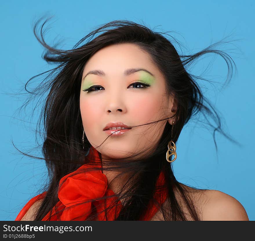 Attractive asian woman on blue