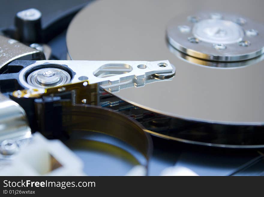 Closeup of the platters and read/write head of a computer hard drive. Closeup of the platters and read/write head of a computer hard drive