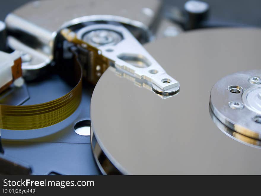 Closeup of the platters and read/write head of a computer hard drive. Closeup of the platters and read/write head of a computer hard drive