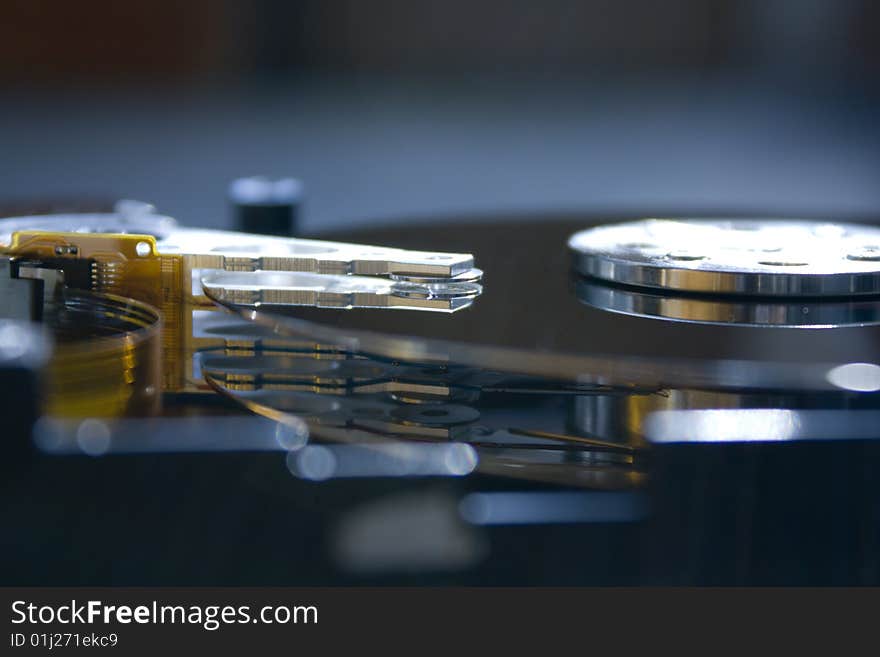 Closeup of the platters and read/write head of a computer hard drive. Closeup of the platters and read/write head of a computer hard drive