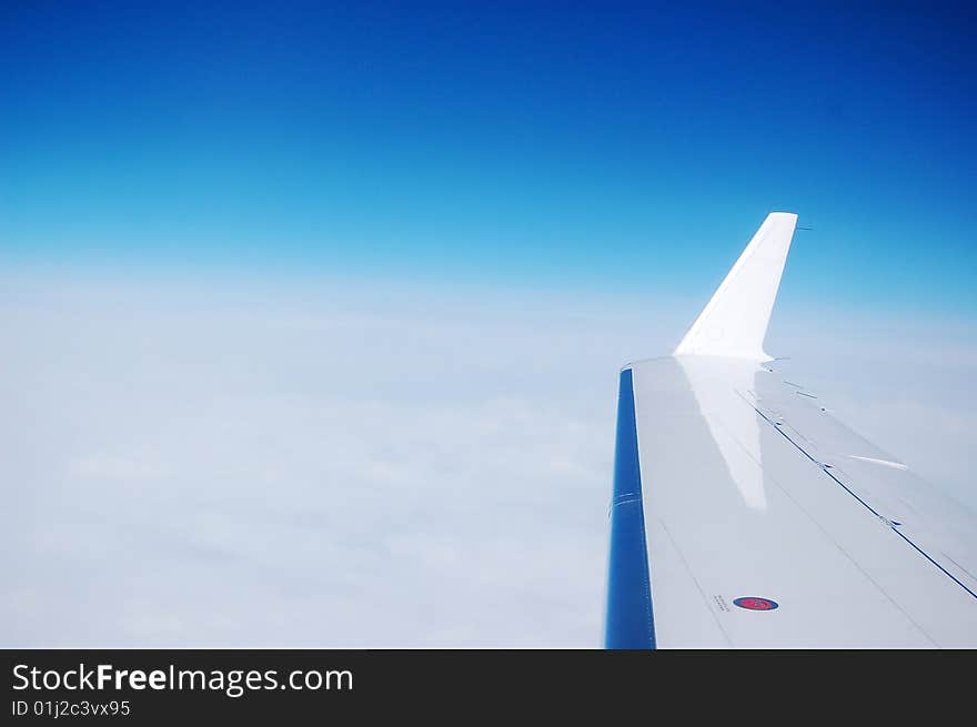 Peaceful sky and an airplane wing