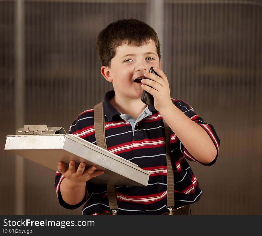 Little boy in adult clothes on cell phone