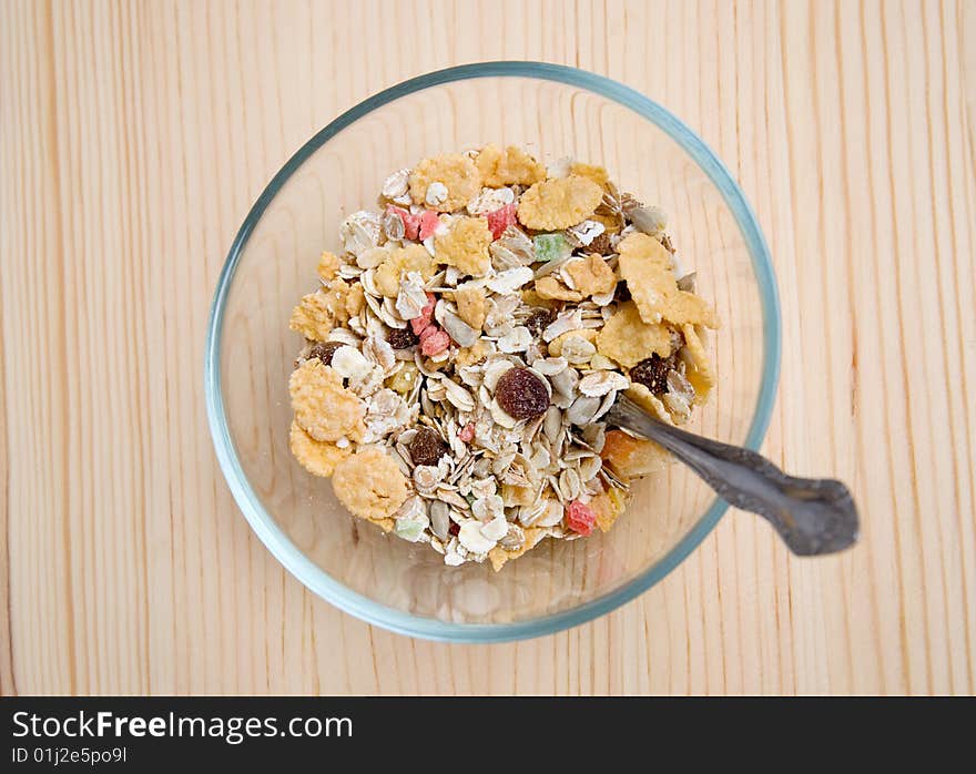 Dish with muesli on wooden table