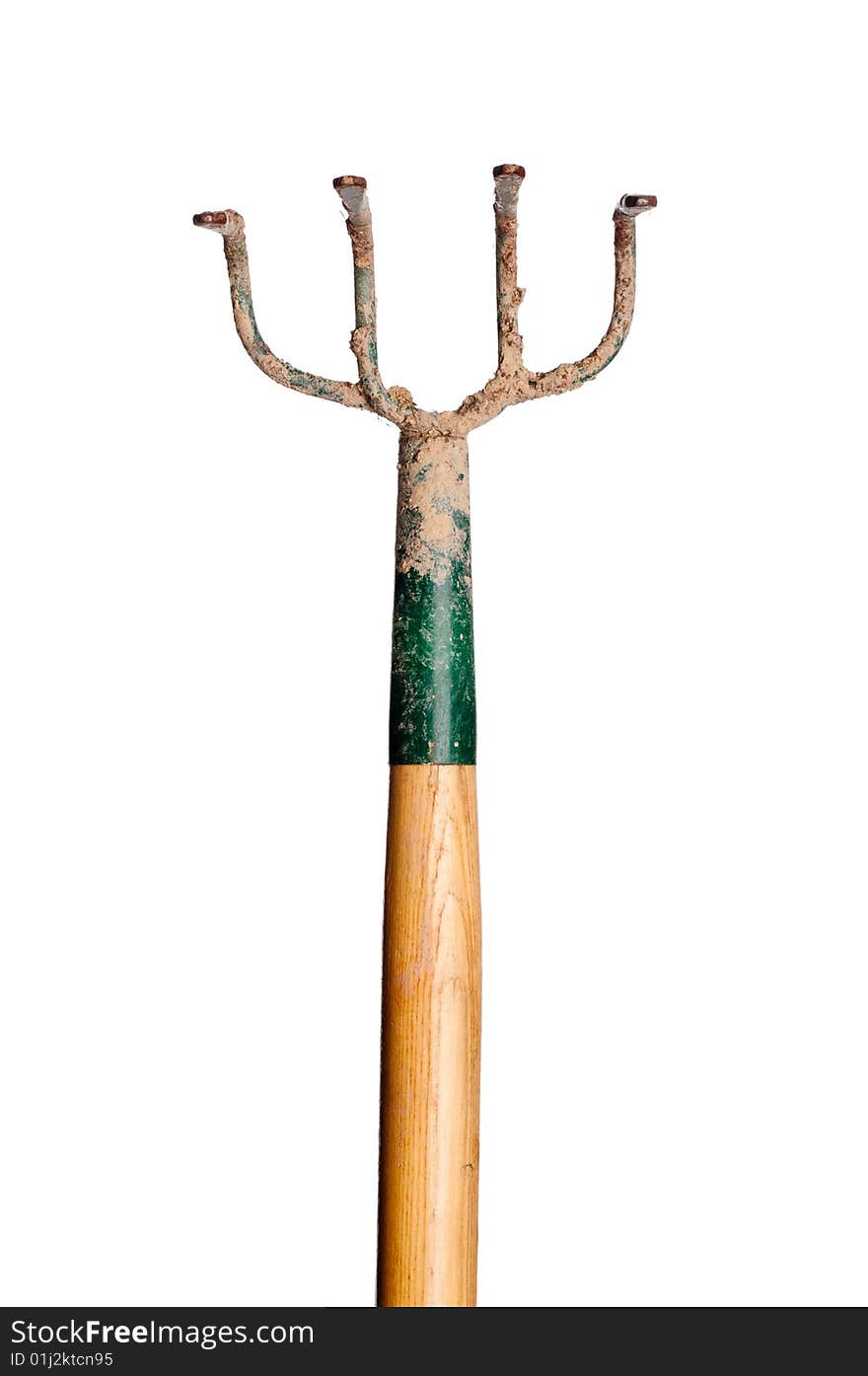 A vertical view of a wood and metal garden hoe covered with dirt on white