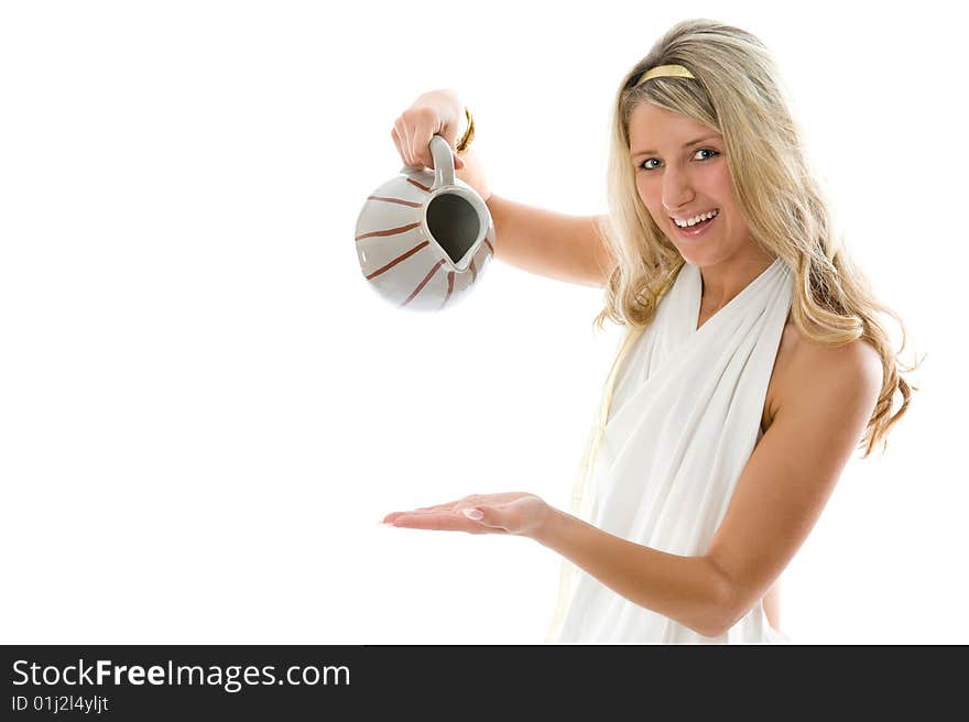 The young attractive girl pours milk from a jug. Close-up portrait isolated on white background