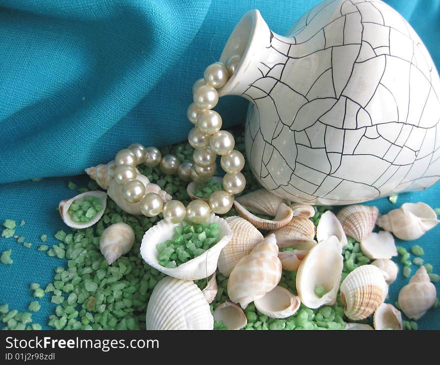 Still life. Vase, seashells and pearl bead