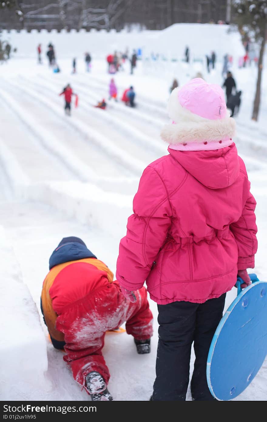 Children On Ice Slope In Park