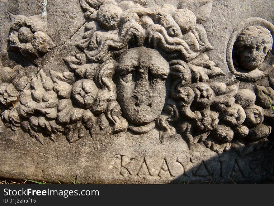 An ancient Greek Sarcophagus, featuring the carved head of a woman and the name Klaudia written in Greek. Church of St John, Selcuk, Turkey. An ancient Greek Sarcophagus, featuring the carved head of a woman and the name Klaudia written in Greek. Church of St John, Selcuk, Turkey