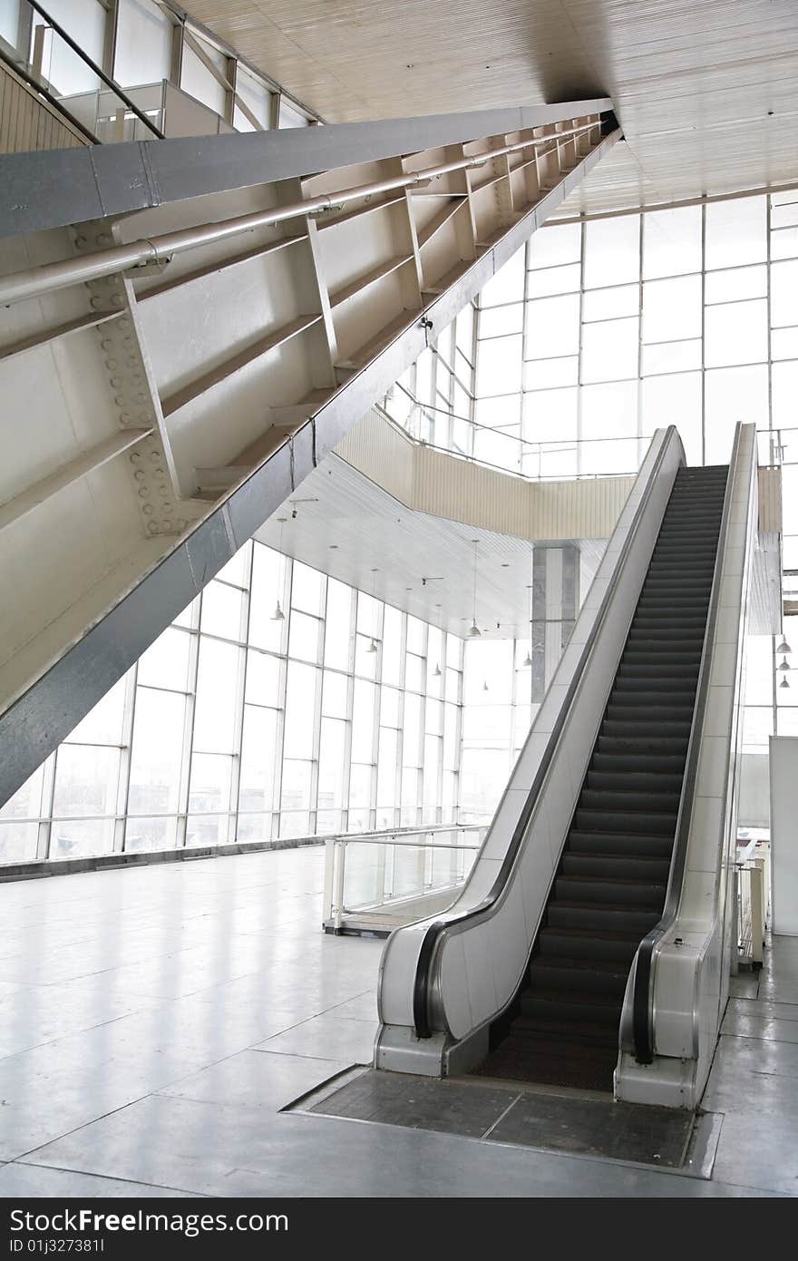 Glass hall with escalator, modern interior