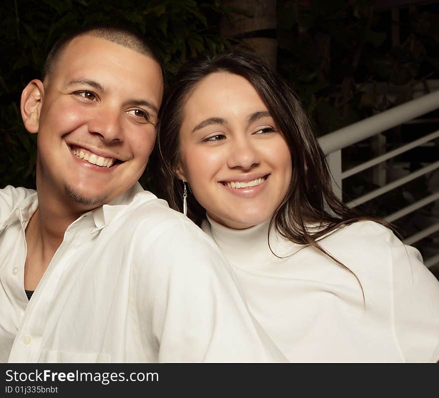 Young couple smiling and glancing away