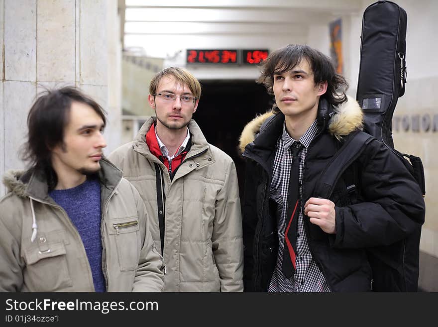 Three young musicians at metro station