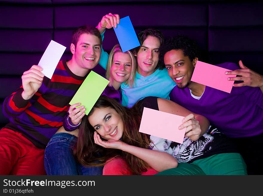 Closeup portrait of happy young teenagers holding signs