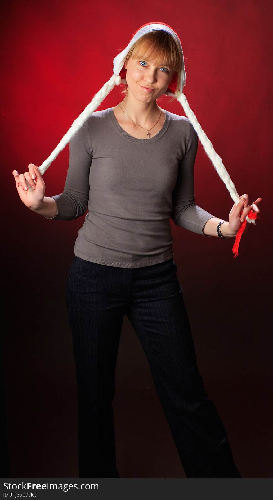 Woman wearing a santa hat on a red background