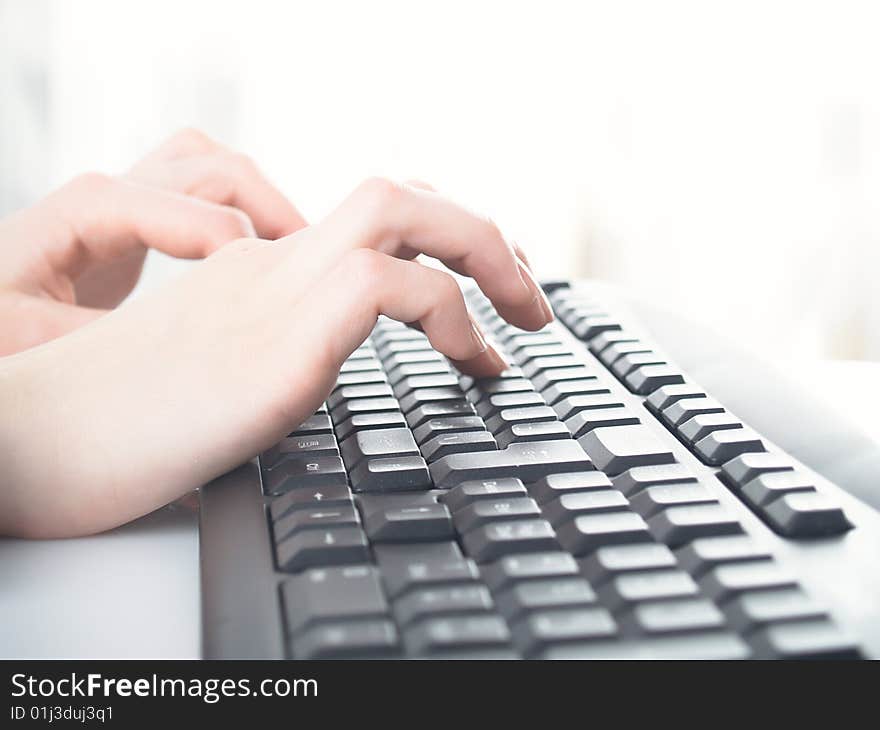 Girl hands typing on the background. Girl hands typing on the background