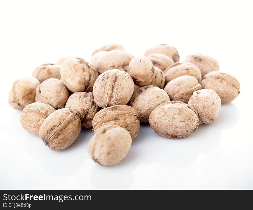 Whole  walnuts on white background.