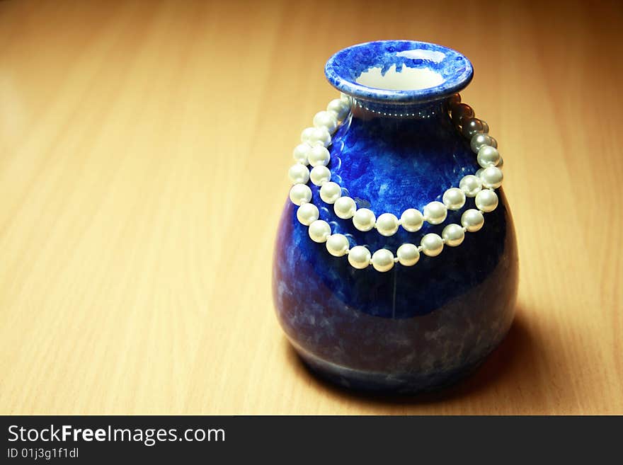 Blue vase and white necklace. Blue vase and white necklace