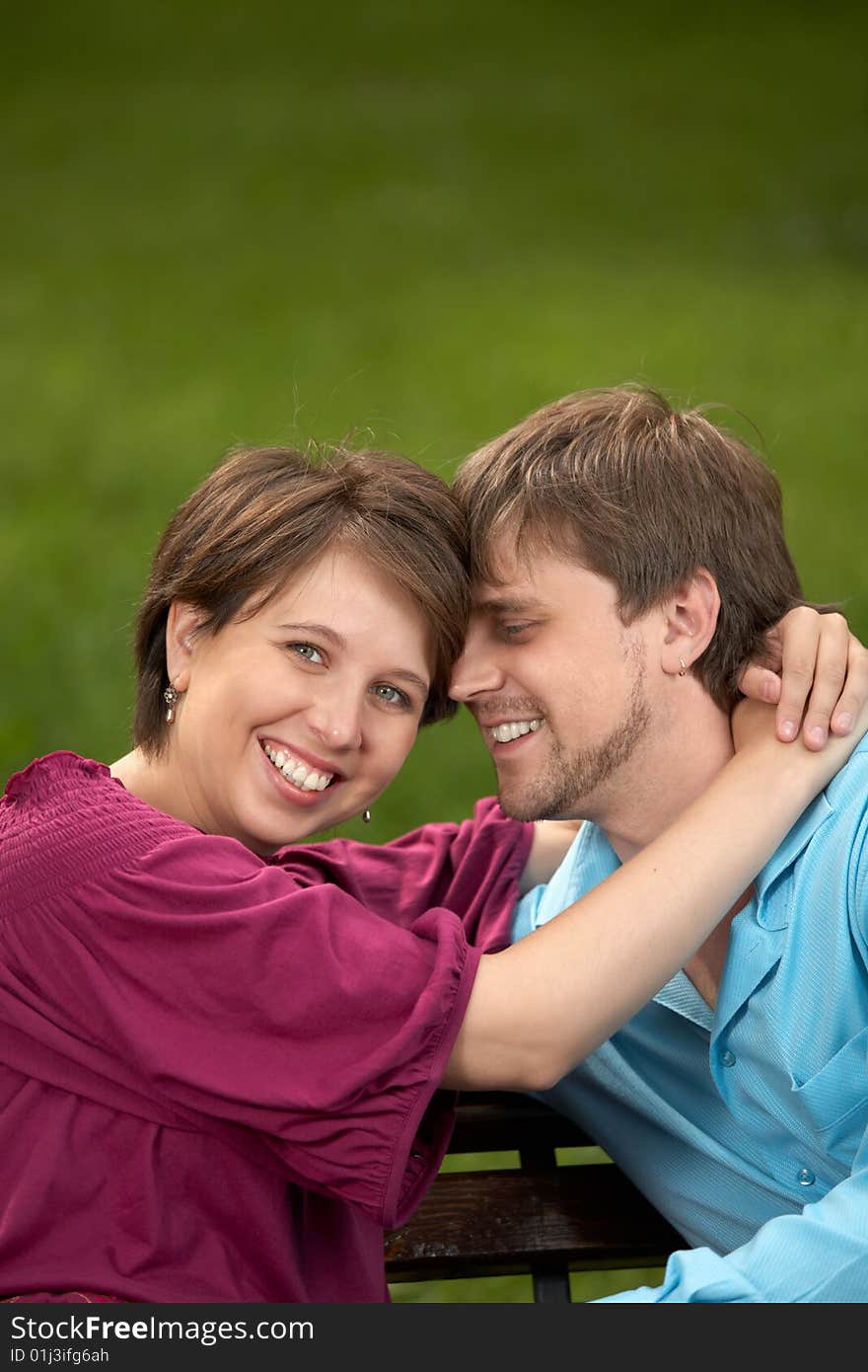 The happy couple embraces in a summer garden. The happy couple embraces in a summer garden