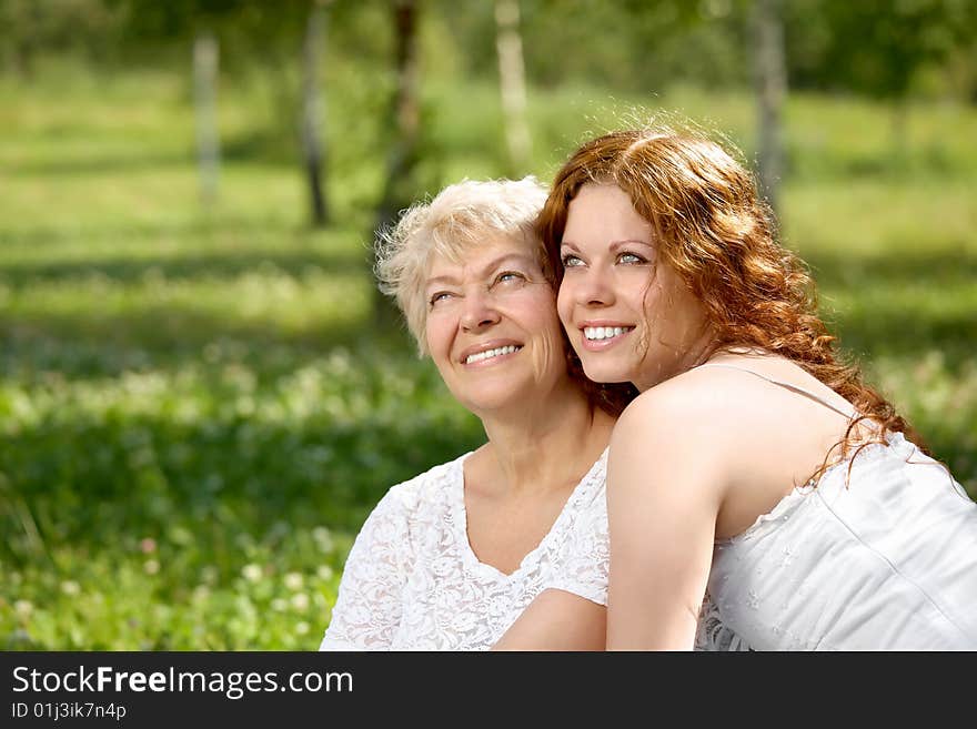 Happy daughter and mother in a summer garden. Happy daughter and mother in a summer garden