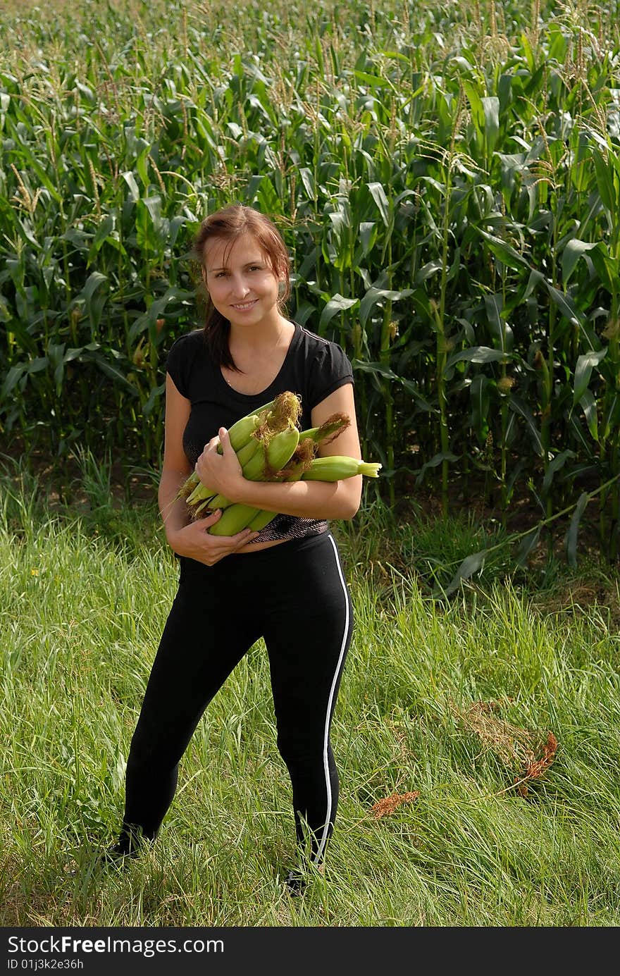 The girl in a floor with corn in hands. The girl in a floor with corn in hands