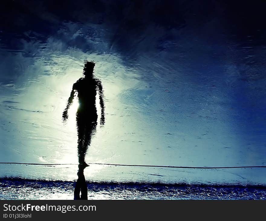 Reflection of man's silhouete in the beach. Reflection of man's silhouete in the beach