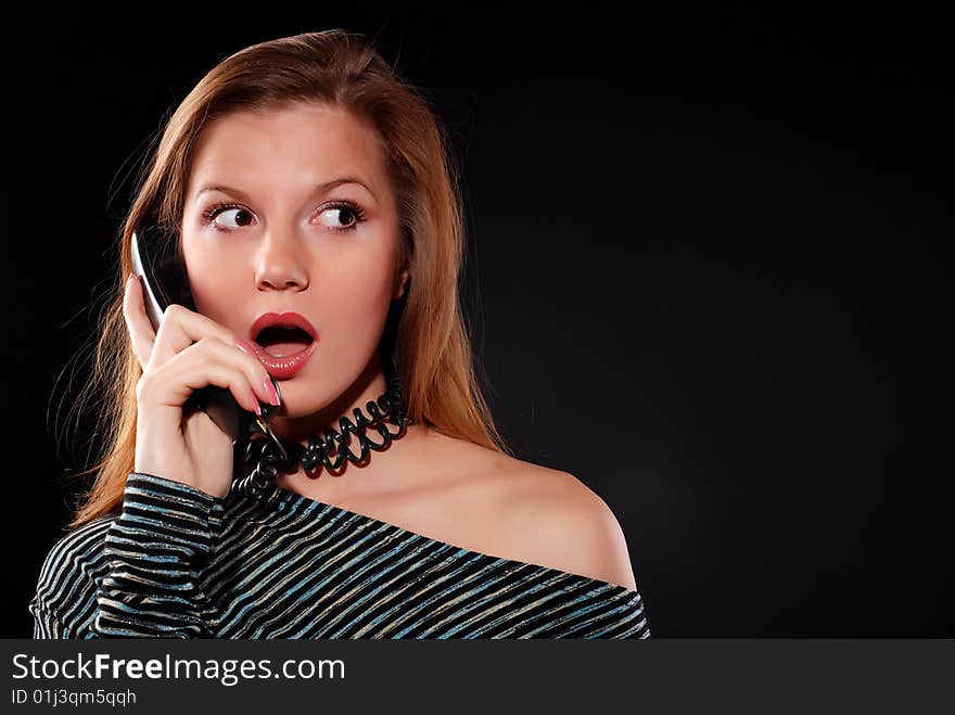 Young beautiful woman with black telephone receiver. Young beautiful woman with black telephone receiver