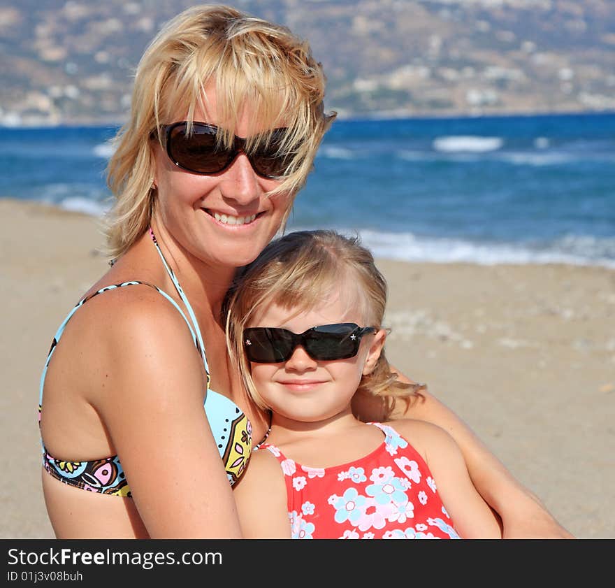 Happy mum with a daughter have a rest on the sea