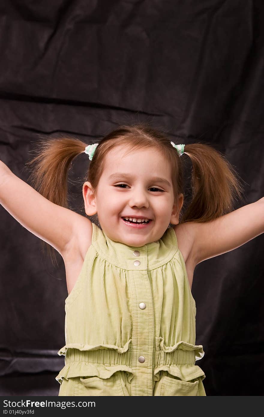 Playful girl on the black background