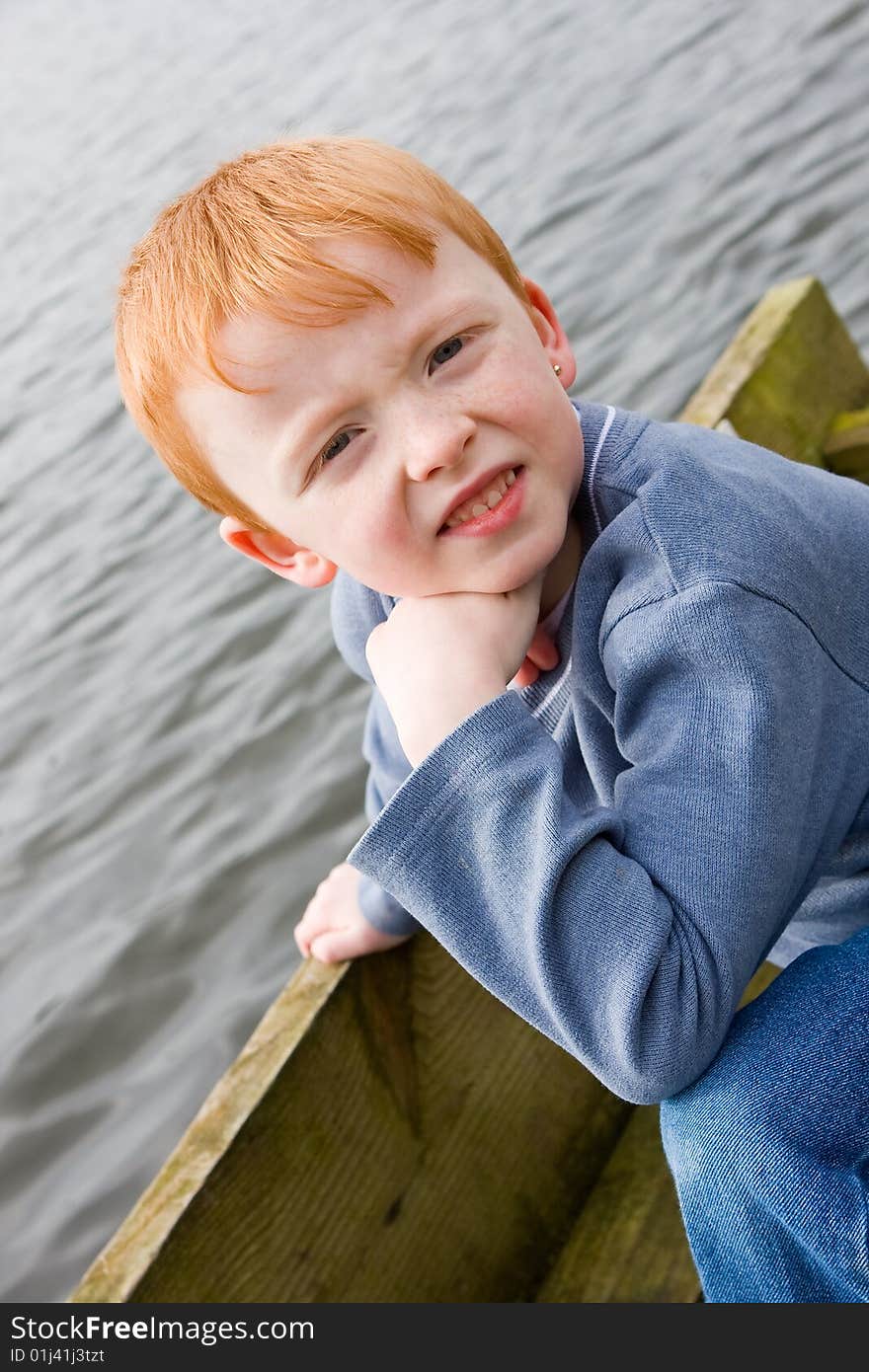 Boy on the edge of a jetty