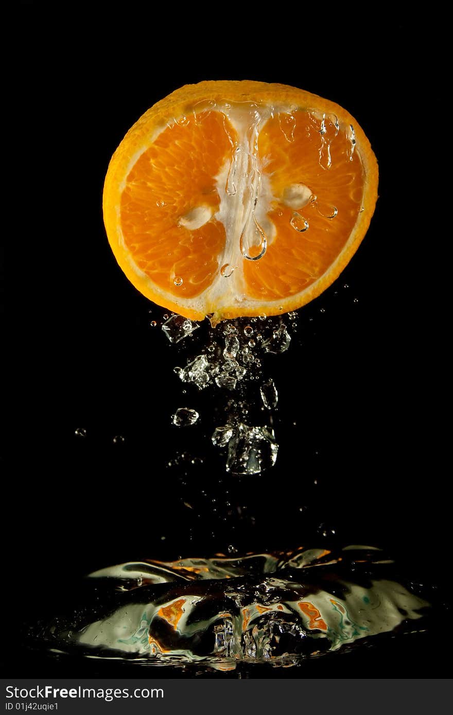 Orange in water on a black background