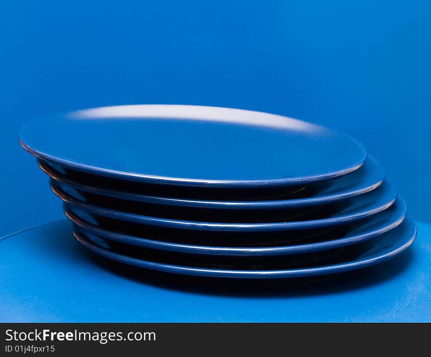 Stack of blue plates on a blue background. Stack of blue plates on a blue background