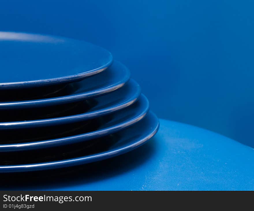 Stack of blue plates on a blue background