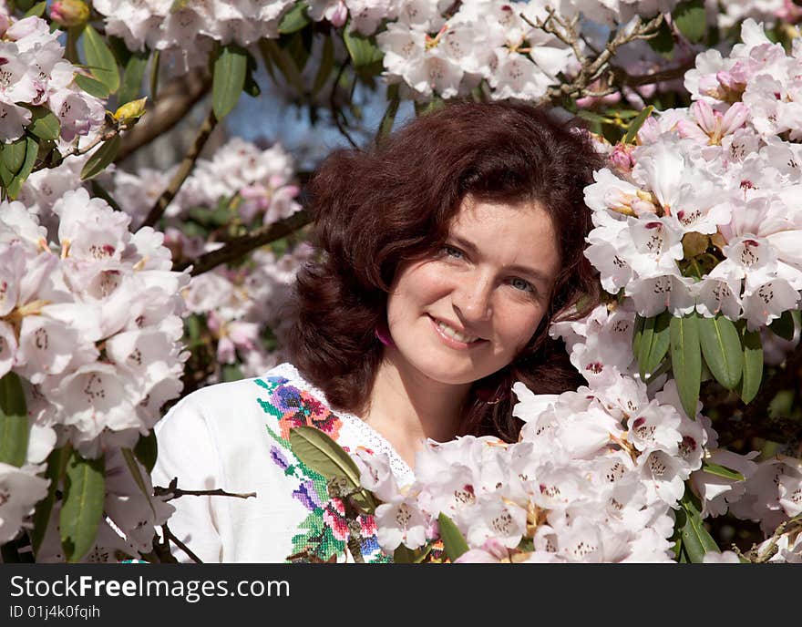 Smiling girl in flowering bush